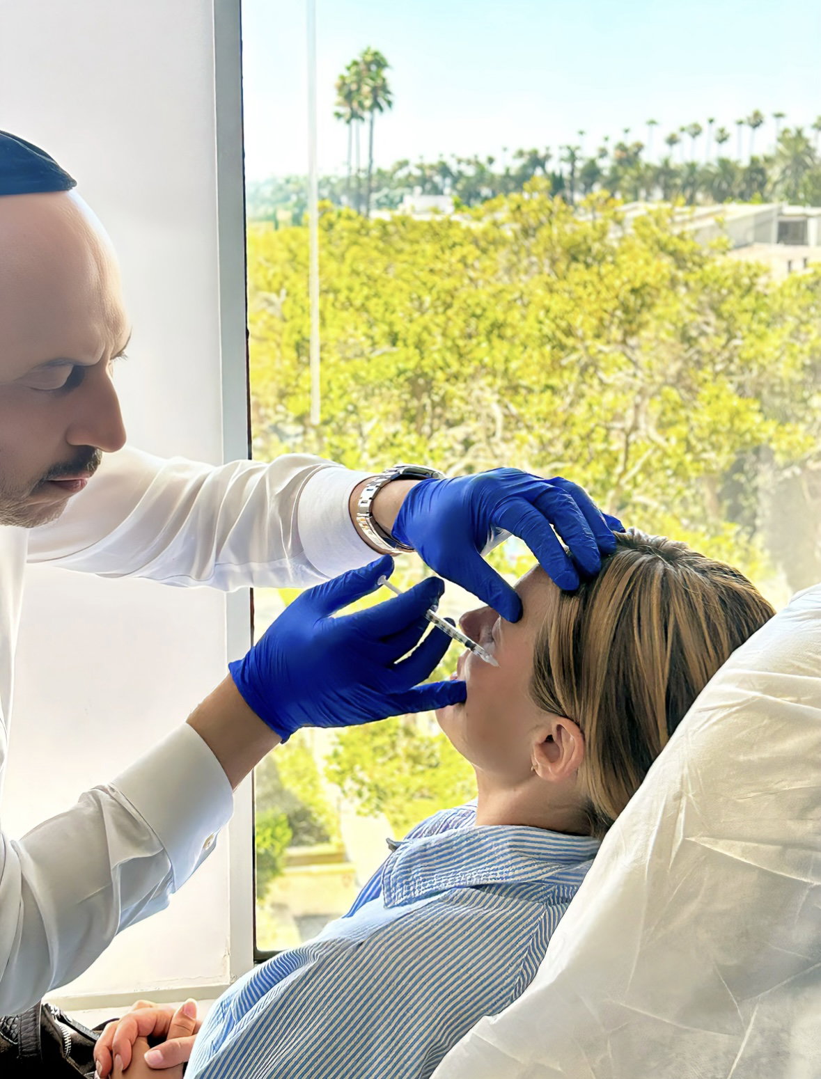 Dual board-certified physician performing precise Botox injection treatment in Beverly Hills medical office